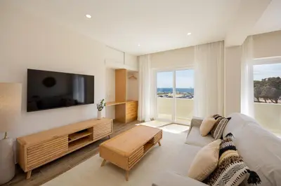 a living room with a couch and a flat screen tv at Pontalaia Ocean View in Sagres