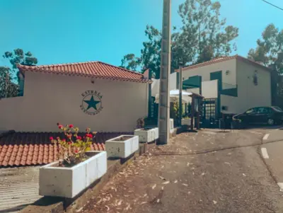 a building with a car parked in front of it at Estalagem Estrela in Estrela