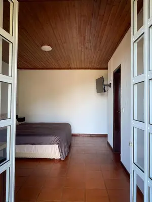 a bedroom with a bed and a wooden ceiling at Estalagem Estrela in Estrela