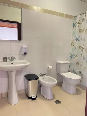 a bathroom with a sink and a toilet and a bidet at Estalagem Estrela in Estrela