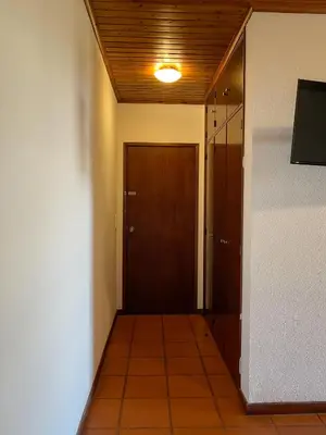 a hallway with a door and a tiled floor at Estalagem Estrela in Estrela