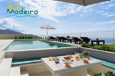 a table with food on it next to a swimming pool at OurMadeira - Villa Adagio in Estreito da Calheta