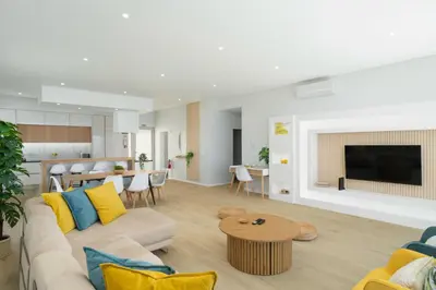 a living room with a couch and a table at OurMadeira - Villa Adagio in Estreito da Calheta