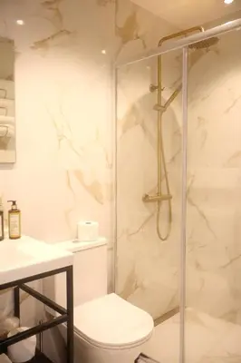 a bathroom with a shower and a toilet at Suites Do Carmo in Funchal