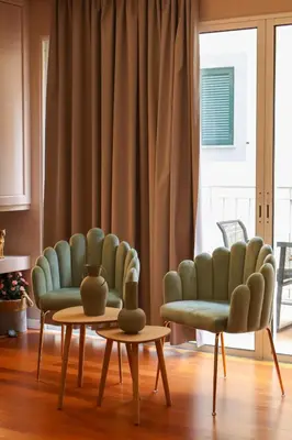 two chairs and a table in a living room at Suites Do Carmo in Funchal