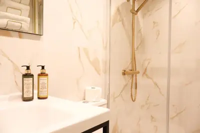 a bathroom with two bottles of essential oils on a sink at Suites Do Carmo in Funchal