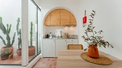 a kitchen with a table with plants on it at Stylish Slow Living 1 BDR House by LovelyStay in Vila do Bispo
