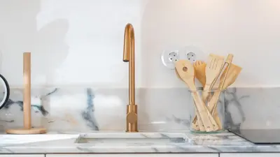 a kitchen sink with a faucet and wooden utensils at Stylish Slow Living 1 BDR House by LovelyStay in Vila do Bispo