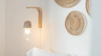 a light fixture hanging on a wall with plates at Stylish Slow Living 1 BDR House by LovelyStay in Vila do Bispo