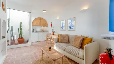 a living room with a couch and a table at Stylish Slow Living 1 BDR House by LovelyStay in Vila do Bispo