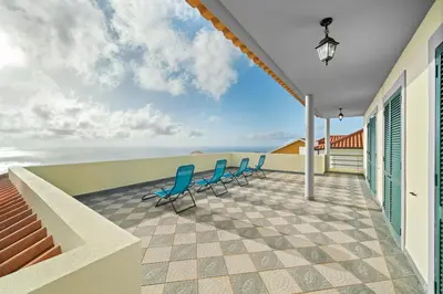 a balcony with chairs and a view of the ocean at Casa Carlota by Atlântica in Santa Cruz