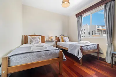 a bedroom with two beds and a window at Casa Carlota by Atlântica in Santa Cruz