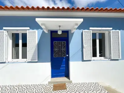a blue door and windows on a house at Casa da Porta Azul in Funchal