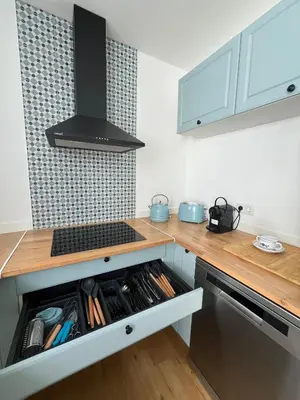 a kitchen with a stove top oven next to a counter at Casa da Porta Azul in Funchal