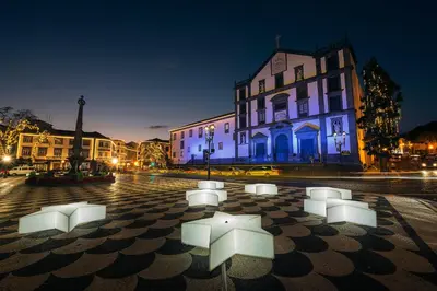 a group of white objects on a street at night at Casa da Porta Azul in Funchal