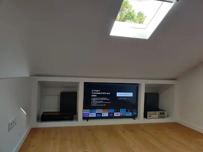 a room with a flat screen tv and a window at Casa da Porta Azul in Funchal