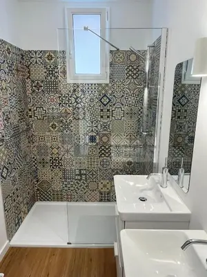 a bathroom with a sink and a tub and a shower at Casa da Porta Azul in Funchal