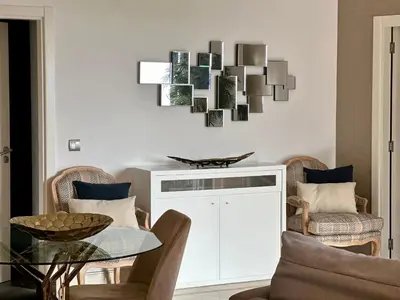 a living room with a glass table and chairs at Sunset Sea View in Funchal