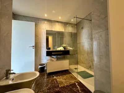 a bathroom with a sink and a toilet and a shower at Sunset Sea View in Funchal
