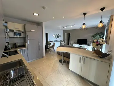 a kitchen with a counter and a dining room at Sunset Sea View in Funchal
