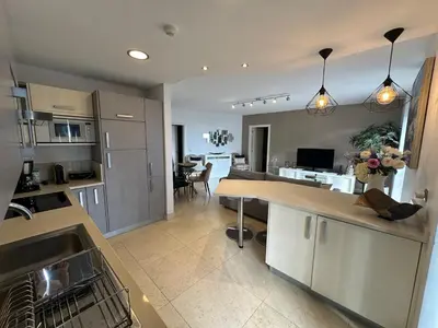 a kitchen with a counter and a dining room at Sunset Sea View in Funchal