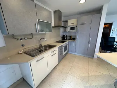 a kitchen with white cabinets and a sink at Sunset Sea View in Funchal