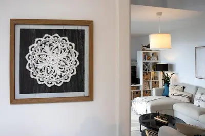 a living room with a painting on the wall at Vila Rouxinol in Arco da Calheta