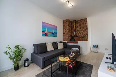 a living room with a couch and a table at Casa Do Sol in Arco da Calheta