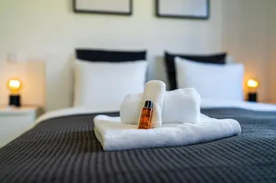 a towel with a pen on top of a bed at Casa Do Sol in Arco da Calheta