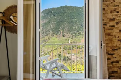 a room with a window with a view of a mountain at Landure by Homie in São Vicente