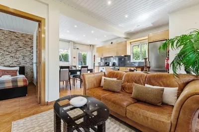 a living room with a couch and a table at Landure by Homie in São Vicente