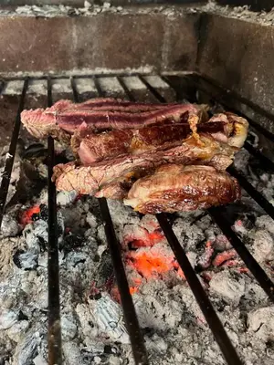 three pieces of meat cooking on a grill at Casa da Rocha by Pleasantconcept in Santana