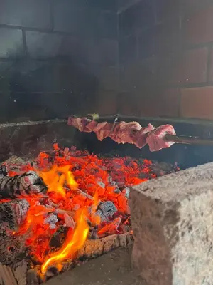 a grill with meat on it with flames at Casa da Rocha by Pleasantconcept in Santana