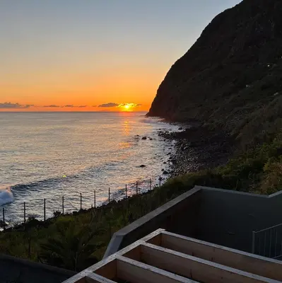 a sunset over a beach with the ocean at Casa da Rocha by Pleasantconcept in Santana