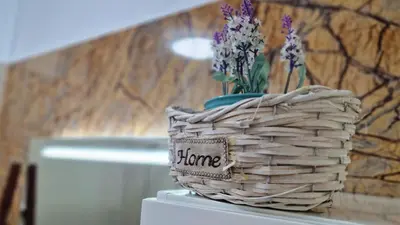 a basket with flowers sitting on top of a refrigerator at Pino's Getaway by LovelyStay in Funchal
