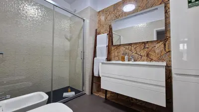 a bathroom with a sink and a glass shower at Pino's Getaway by LovelyStay in Funchal