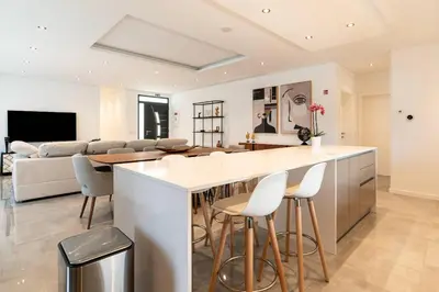 a kitchen and living room with a bar and a couch at Oak Tree Ocean View in Ponta do Sol