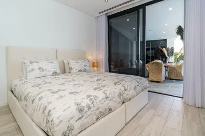 a bedroom with a large bed and a balcony at Oak Tree Ocean View in Ponta do Sol