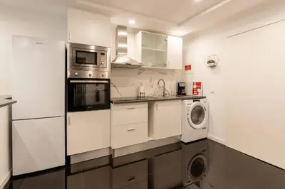 a kitchen with a washing machine and a washer at Tranquilidade, Quiet Apartament in Funchal City Center in Funchal