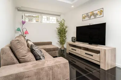 a living room with two couches and a flat screen tv at Tranquilidade, Quiet Apartament in Funchal City Center in Funchal