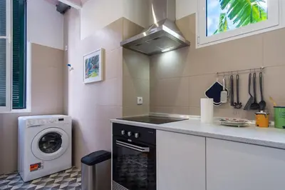 a kitchen with a stove and a washing machine at GuestReady - Relaxing Retreat in Madeira in Machico
