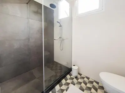 a bathroom with a shower with a toilet and a sink at GuestReady - Relaxing Retreat in Madeira in Machico