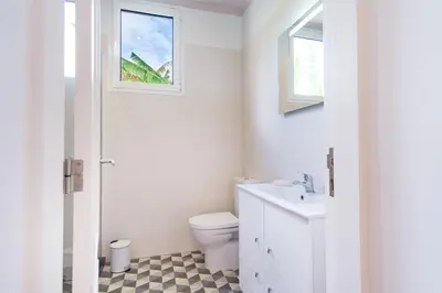 a white bathroom with a toilet and a sink at GuestReady - Relaxing Retreat in Madeira in Machico