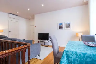 a living room with a table and a television at GuestReady - Relaxing Retreat in Madeira in Machico