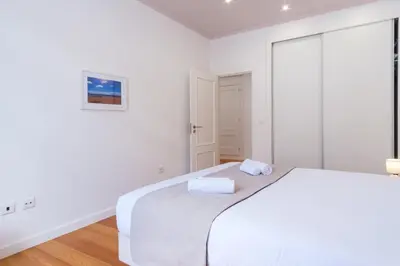 a white bedroom with a bed and a window at GuestReady - Relaxing Retreat in Madeira in Machico
