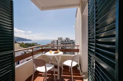 a balcony with a table and chairs and a view at Casa Branca Apartments by Wanderlust Madeira, vacation rentals in Funchal