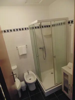 a bathroom with a shower and a toilet and a sink at Casa Branca Apartments by Wanderlust Madeira, vacation rentals in Funchal