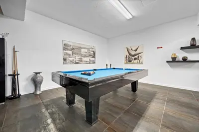 a pool table in a room with art on the wall at São Lourenço Guest House in Caniçal