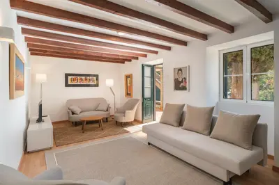 a living room with a couch and a table at OurMadeira - Vintage Garden Apartment in Funchal