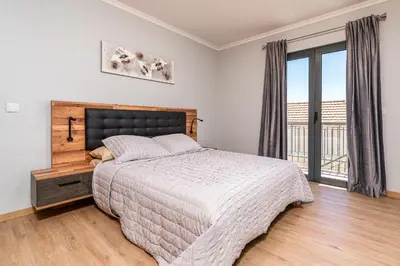a bedroom with a bed and a large window at Goncalves House - AC and private parking in Calheta